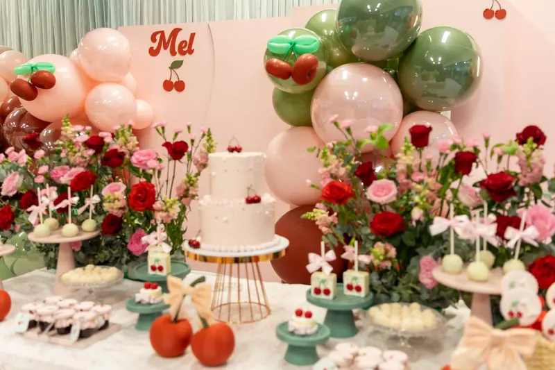 Cereja: Cherries, garden roses and a pink and sage balloon garland for Mel's first birthday.