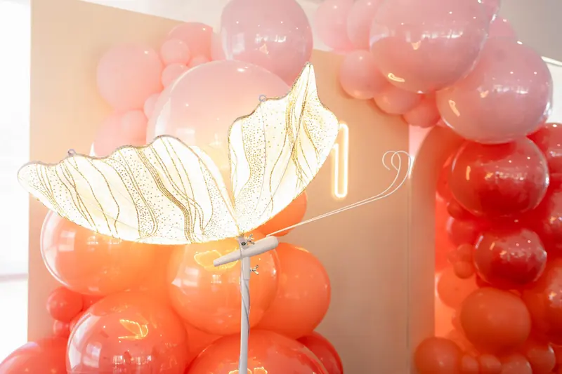 Coral balloon garland with a gold butterfly light